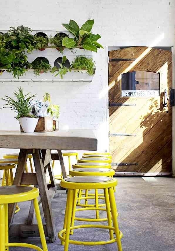 Yellow industrial stool: Remodelista #interior #wood #yellow #plants
