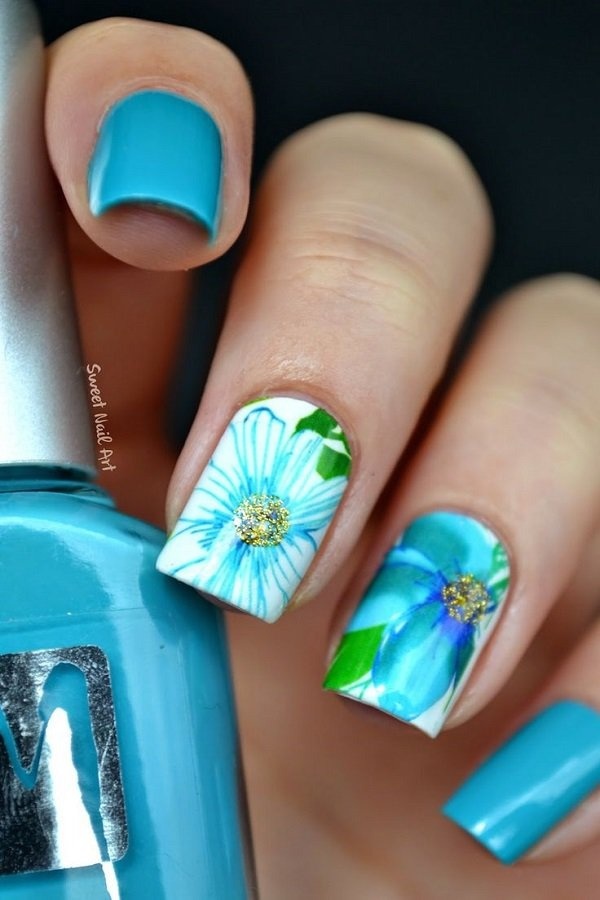 Blue floral nail art design. This pretty little nail art design sports a blue and white base colors with a lighter blue polish on top for th