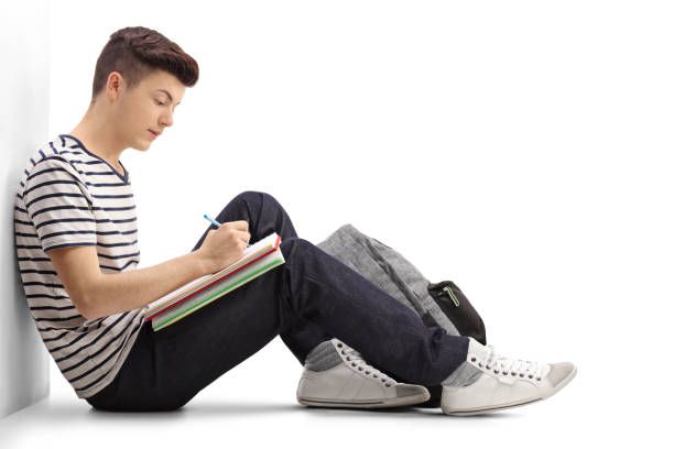 Teen student writing in a notebook