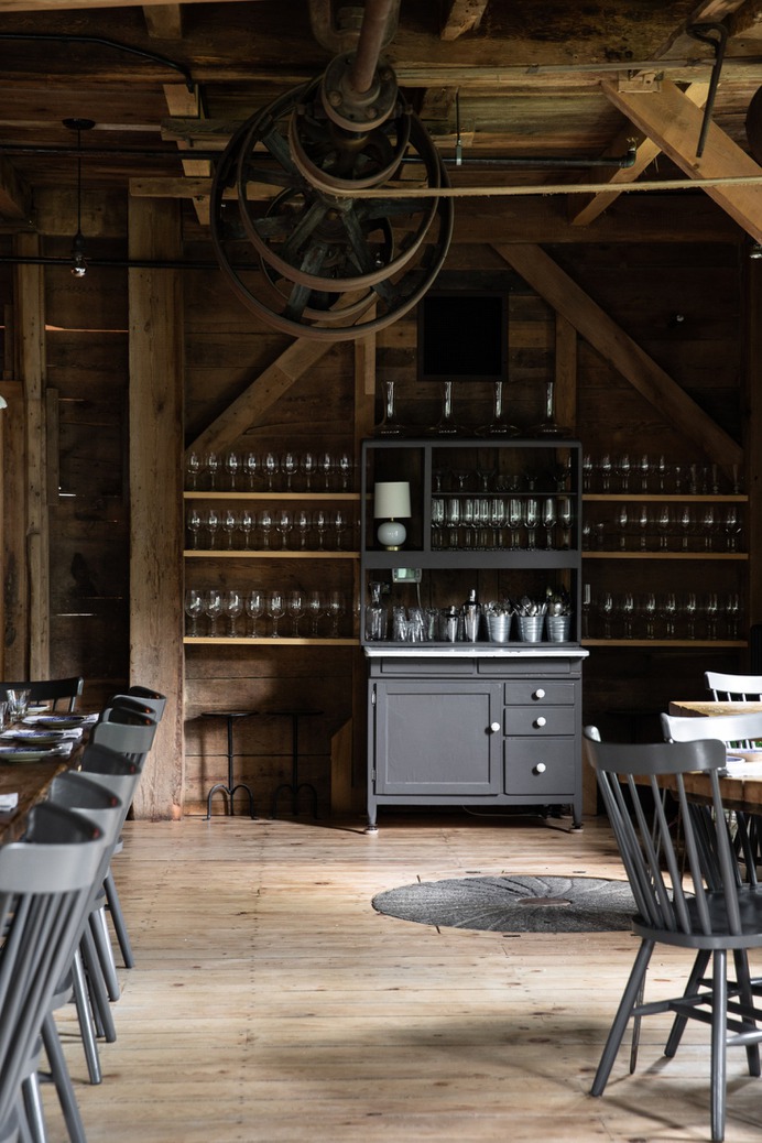 On one wall, a vintage hutch holds the restaurant's glassware.
