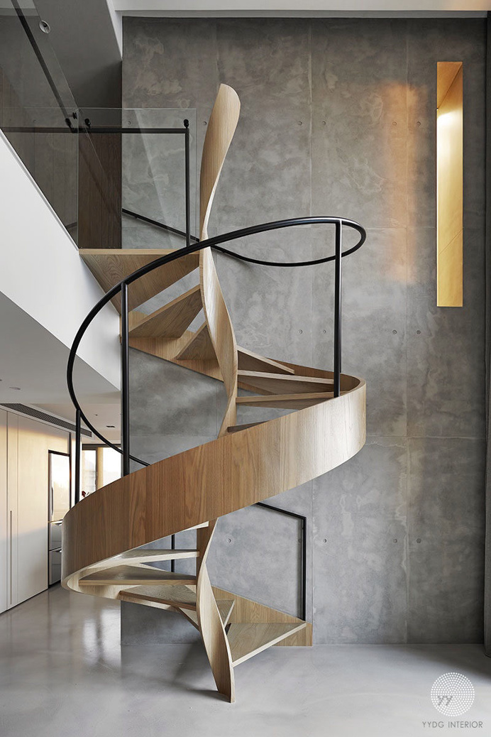 A Sculptural Spiral Staircase Makes A Statement In This Home's Interior