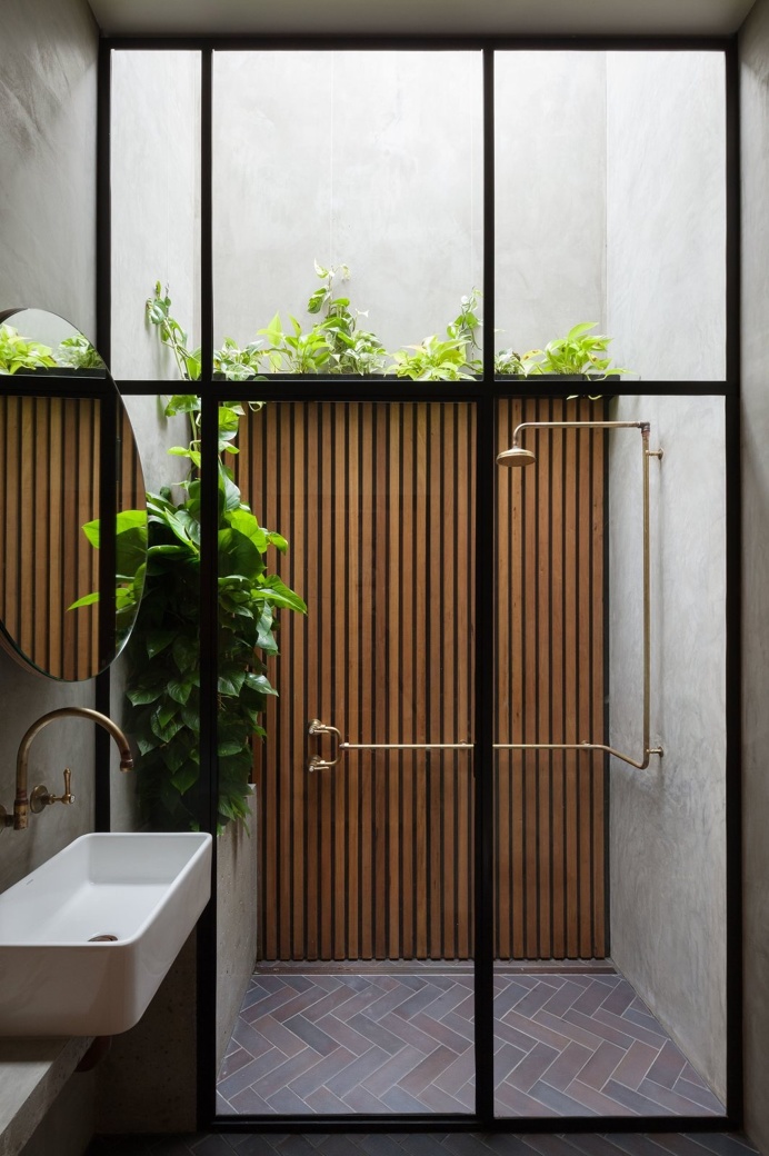 Contemporary concrete shower with skylight. Double Life House by Breathe Architecture. #shower #bathroom #skylight #contemporary #glassdoor