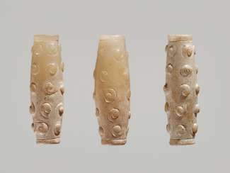 THREE TINY BI-CONICAL BEADS IN WHITE JADE WITH DELICATELY CARVED SCROLLS IN RELIEF