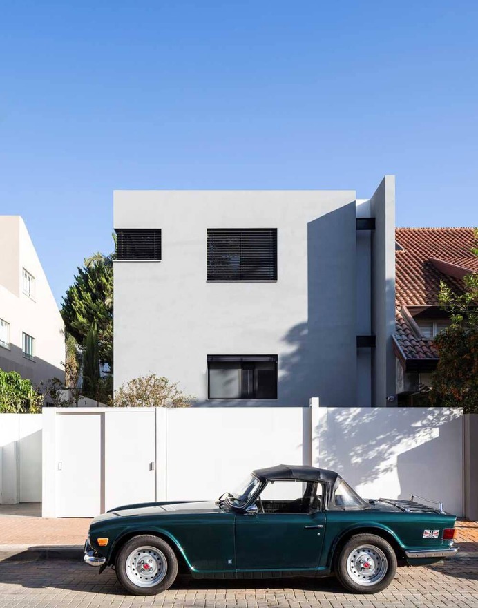 An Architectural Mass of Two Asymmetrical Blocks in Size, Color and Shape