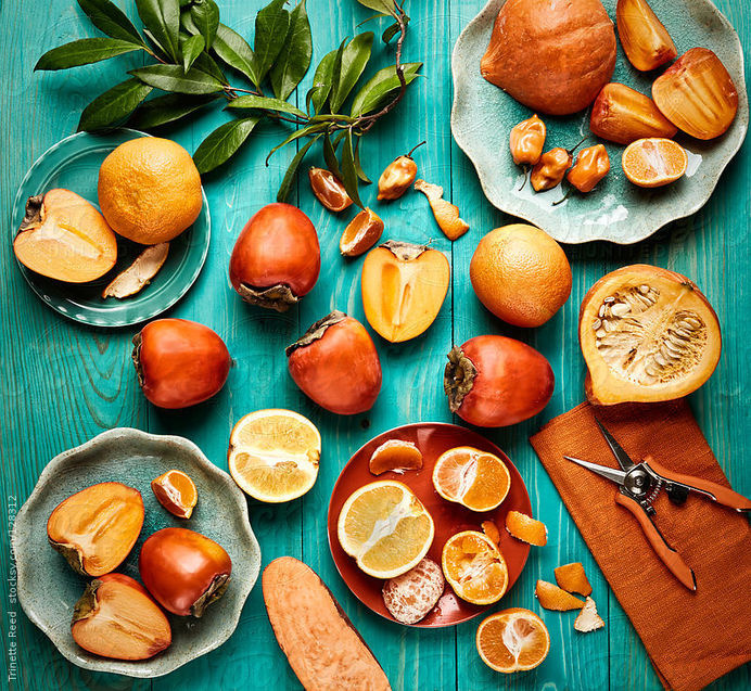Still life of various orange colored fruits and vegetables on blue wood by trinettereed | Stocksy United #fruit #orange #wood #vegetable #blue