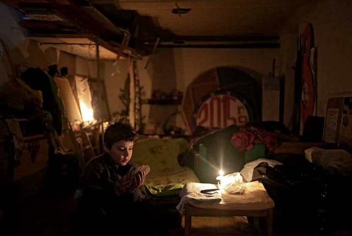 A child plays cards in the local Palace of Culture, used as a bomb shelter during fighting