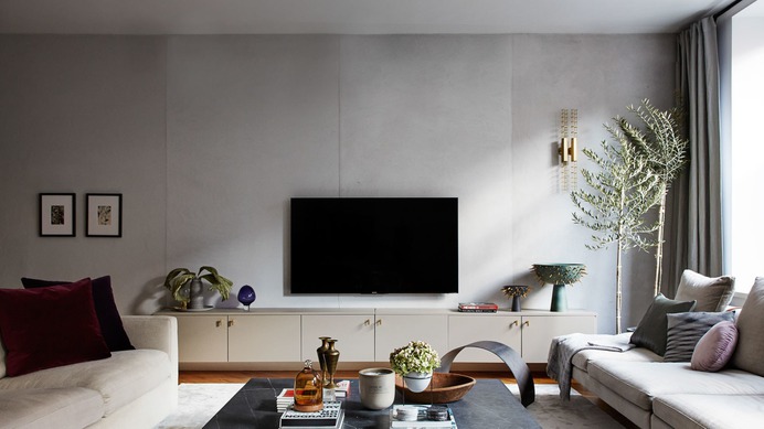 Tali Roth's NYC apartment with a faux concrete wall