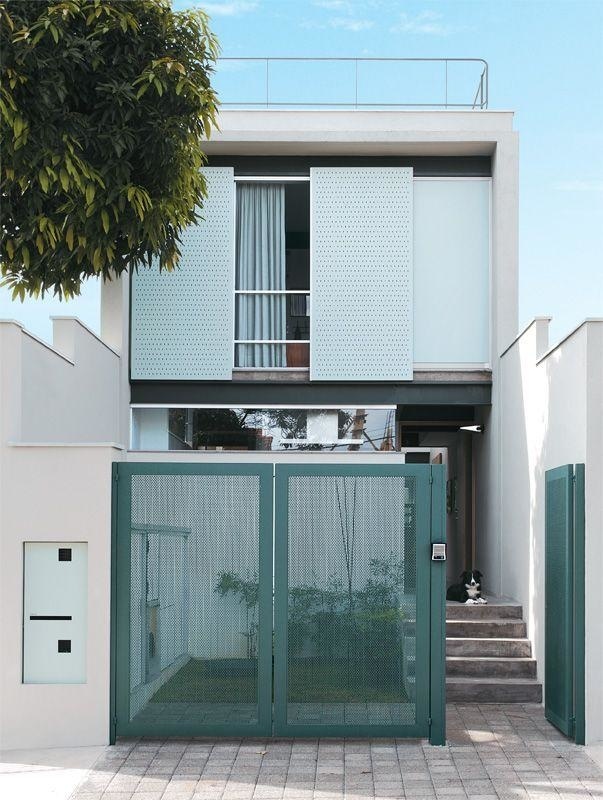 Facade of Narrow House with Green Gate