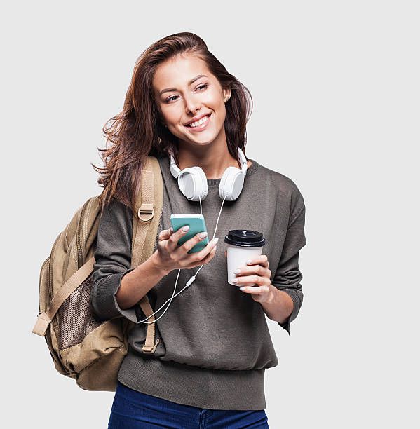Happy young student girl using smart phone