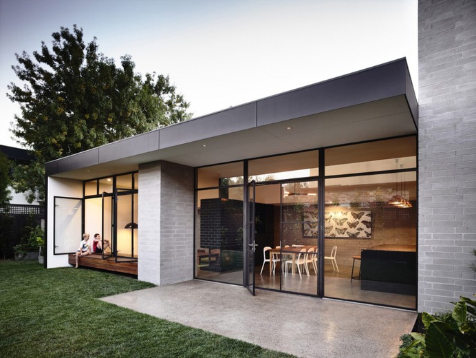 Glass storefront to backyard. Bench extending from inside to outdoors