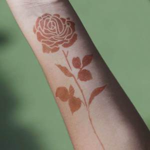 Rose - temporary tattoo of a rose on arm Create your own rose henna flower tattoo with Mihenna's sticker stencils to get flawless designs without any smudges or smears. Perfect henna for beginners.