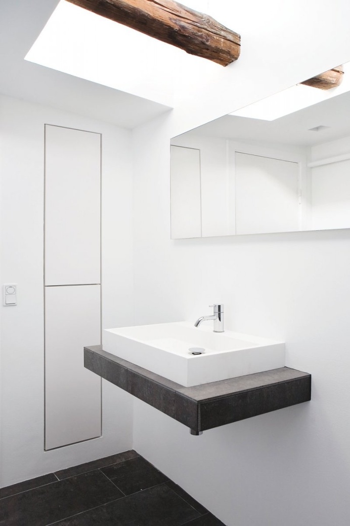Bathroom vanity under skylight. Fredgaard Penthouse by Norm.Architects. © Jonas Bjerre-Poulsen. #bathroom #beam #skylight