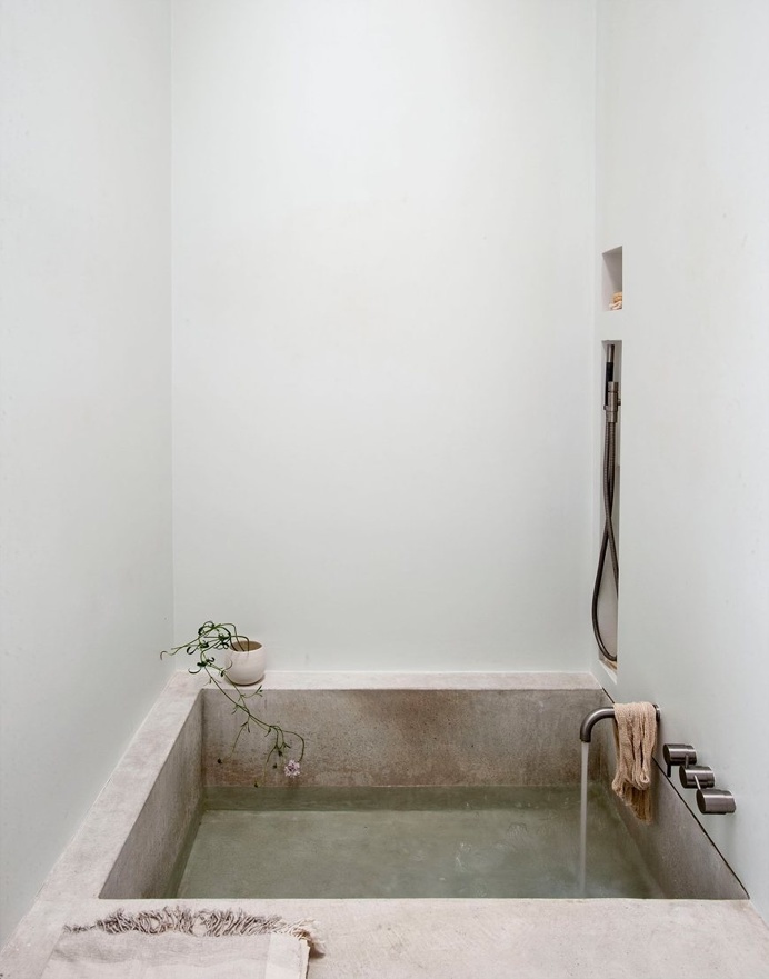 Concrete bathtub in an alcove. Bathroom collection. Photo by Matthew Williams. #bathroom #concrete #alcove #shower