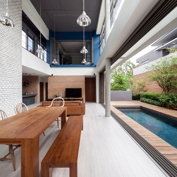 Two Houses Connected to Each Other for Two Brothers with Different Lifestyles