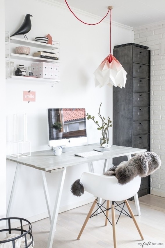 A living room workspace with a great light fixture