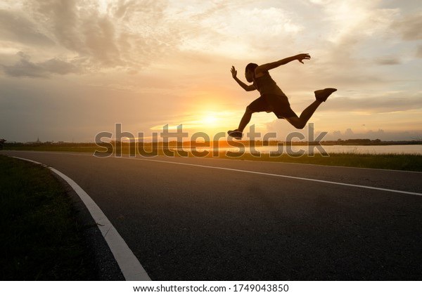 one man running on the street with sunset background