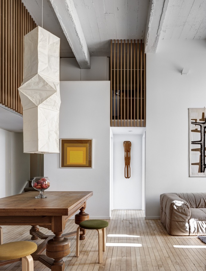 An Akari Ceiling Lamp, Model L5 from the Noguchi Museum Store hangs in the lofty living area of this Brooklyn apartment. Photograph by Bruce Buck, from An Eclectic Apartment Inspired by Japanese Storage Chests in Cobble Hill, Brooklyn.