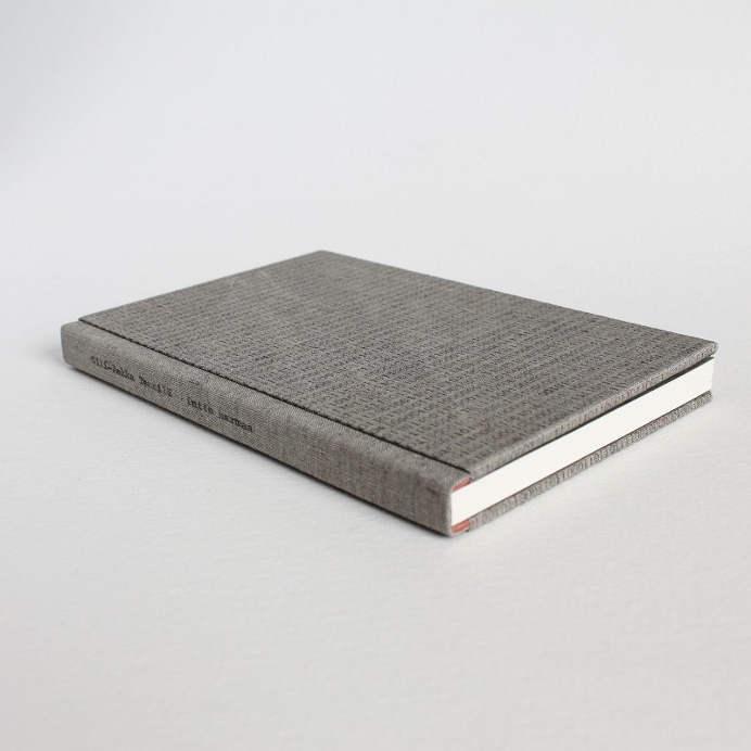 Designer binding by Kaija Rantakari, 2017. A variation of the sewn boards binding with typewritten binary code linen covers and pink leather