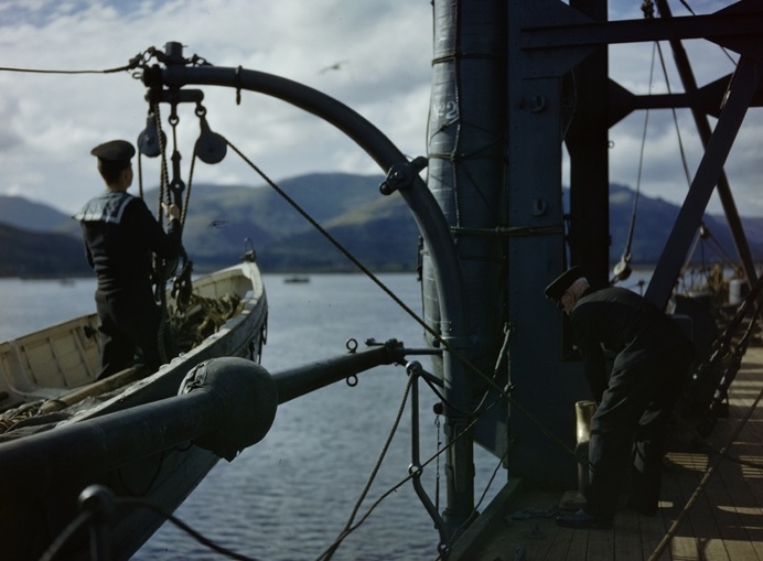 An officer and a rating launch a dinghy from HMS Forth on Holy Loch, Scotland