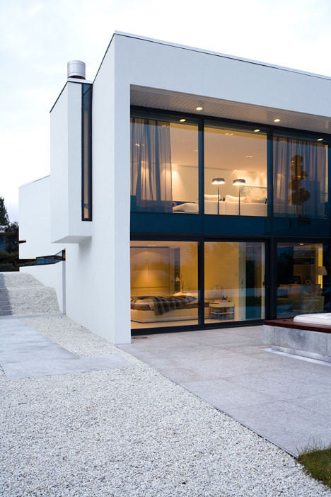 Volcanic stone wall hides doorway into B25 house by PK Arkitektar