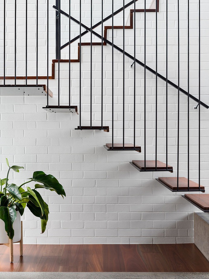 Floating Wood Stairs on metal supports & Metal Rod Guardrail on Brick wall