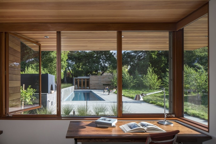 Channeling Midcentury Modern in Northern California - Photo 3 of 7 - Looking out from one of the home offices, Â a board-formed concrete gar