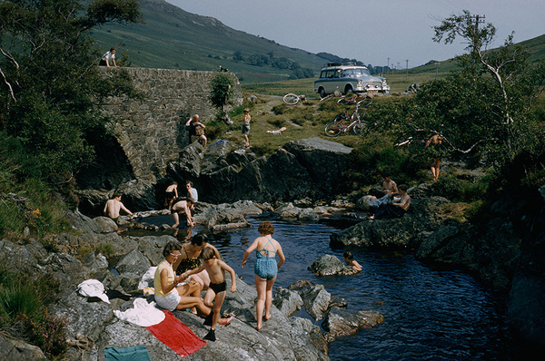 Bikes park near an arched stone bridge above bathers enjoying the water on Arran Island, Scotland, July 1965.Photograph by Robert Sisson, Na #bikes #americana #bathers #photograph #photography #vintage #film #scotland #1965