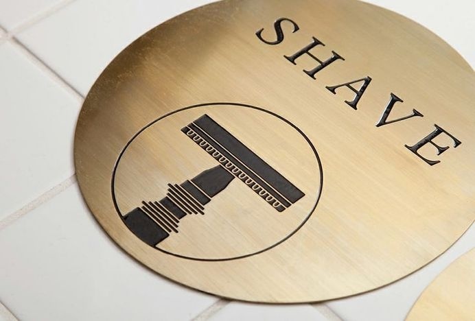 Acid-etched brass signage by ThoughtAssembly for male grooming business Men's Biz #ee