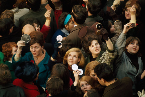 Women use compact mirrors in packed crowd to catch sight of the queen in London, June 1966. #angle #photography