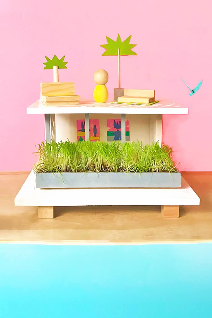 From just a few scraps of wood and simple supplies, you can make your own super-hip, mid-century-modern beachfront DIY up cycled dollhouse in an afternoon!