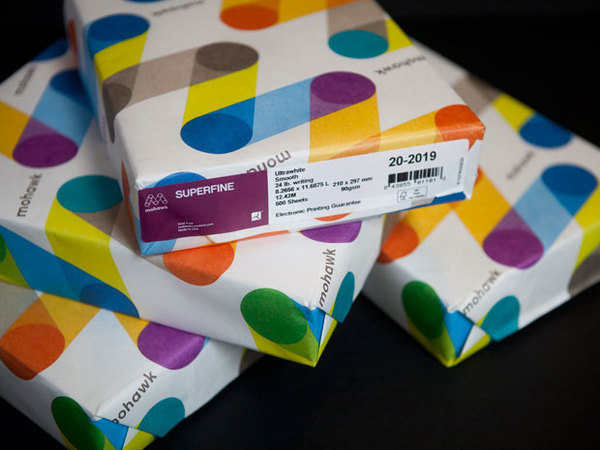 Colorful patterns of the logo appear on ream wraps. #packaging #wrap #wrapper #wrapping #pentagram #paper #mohawk