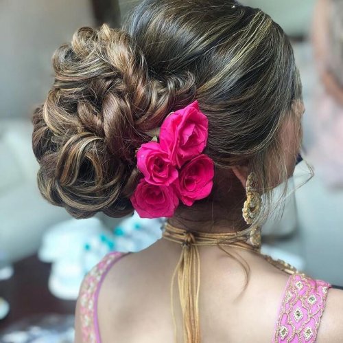 Entangled Waves Tied Into A Bun Decorated With Roses