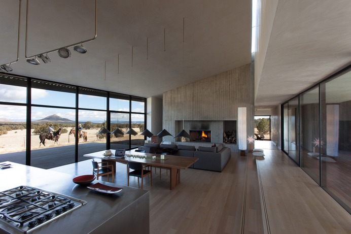 The concrete fireplace in this interior is lovely.