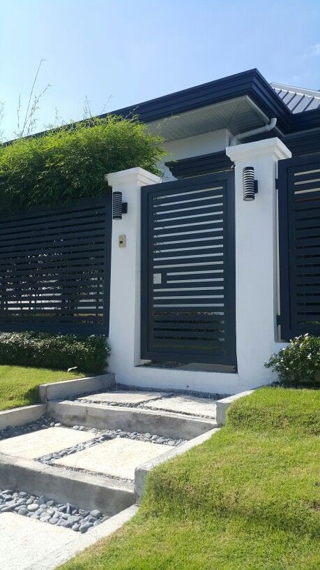 Minimalist facade with clean lines and dark gray, white, and green