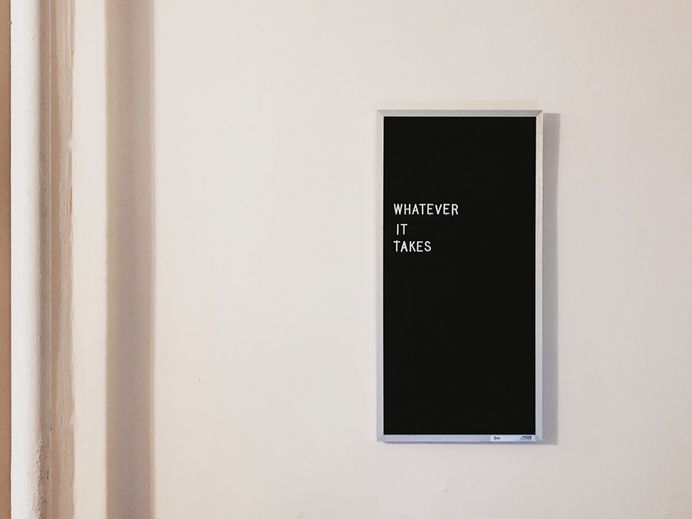 Whatever it takes typography on black felt board frame on white wall