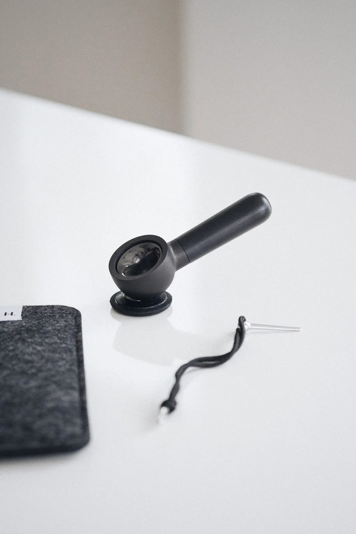 heir handpipe sitting on stand on table
