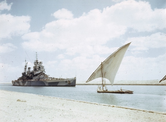 HMS Howe passes through the Suez Canal on her way to join the British Pacific Fleet.
