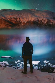 Man Looking At Lake Under Northern Lights