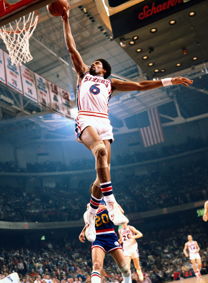 Julius Erving Philadelphia 76ers forward Julius Erving (Dr. J) dunks against the Denver Nuggets at The Spectrum.