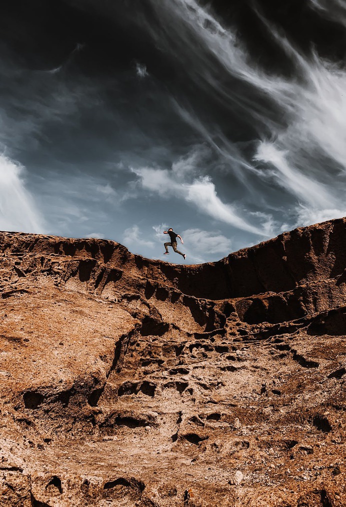 Man running on rocky sandy formation
