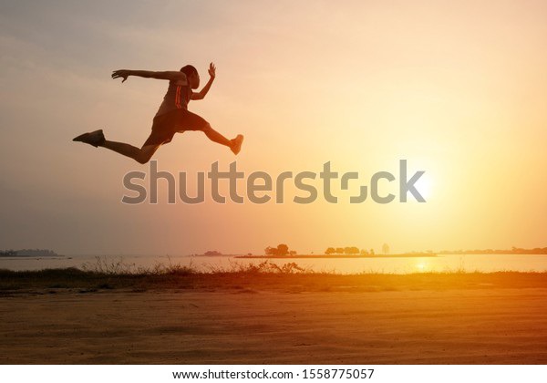 Athlete runner on road with sunset or sunrise , sport and healthy concept