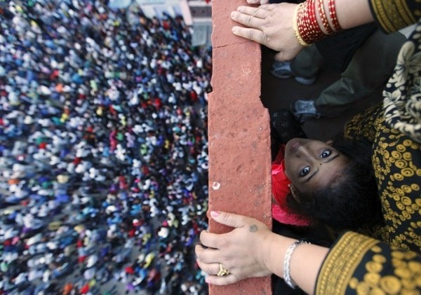 A child looks on as she observes the Bisket festival at the ancient city of Bhaktapur near Kathmandu #2012 #reuters