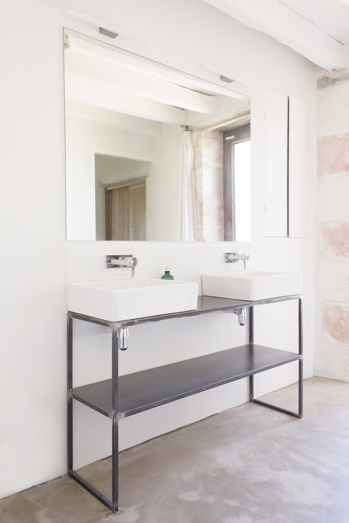 Bathroom sinks on black metal stand, alongside a large mirror on the wall. Project 'Sereine' by Septembre. Photo by Linus Ricard.