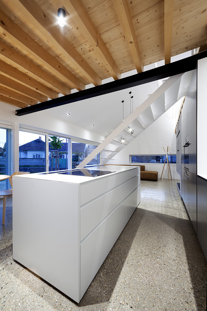 "Under the Calvary" House Has Traditional Shape and Modern Interiors