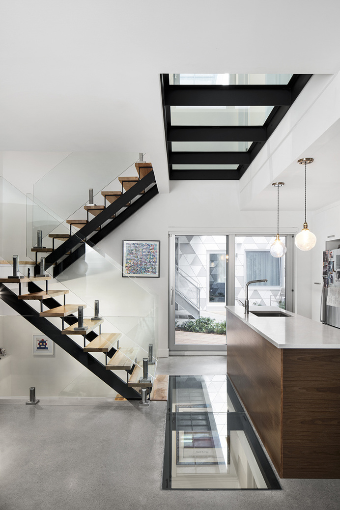 ADHOC's la géode in montreal includes a courtyard for housing optimization and fluidness staircase kitchen open space