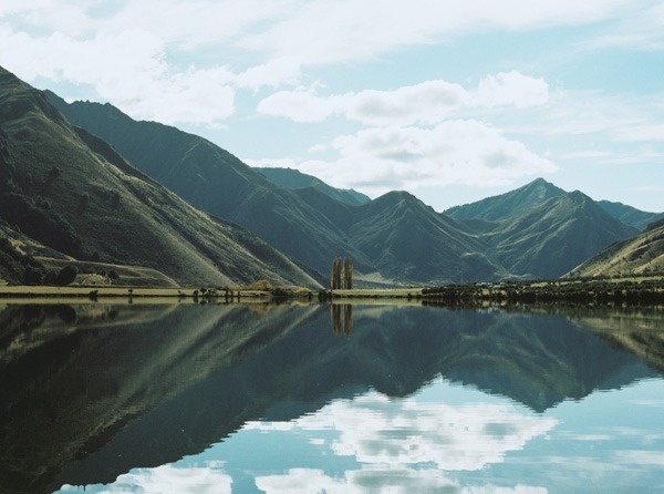 Once Wed - Designer Weddings for Less #zealand #green #clouds #water #grass #sky #mirror #blue #lake #symmetry #mountains #new