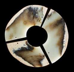AN INTERESTING THREE-SECTION DISC CARVED IN MARBLE-LIKE JADE