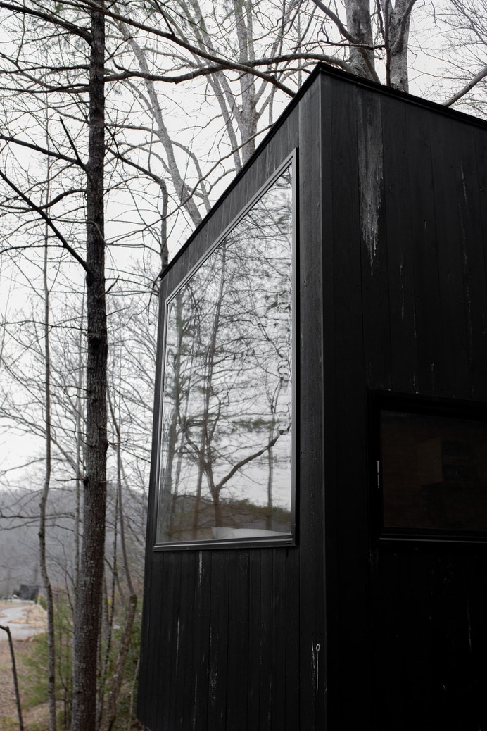 black wooden house with glass window