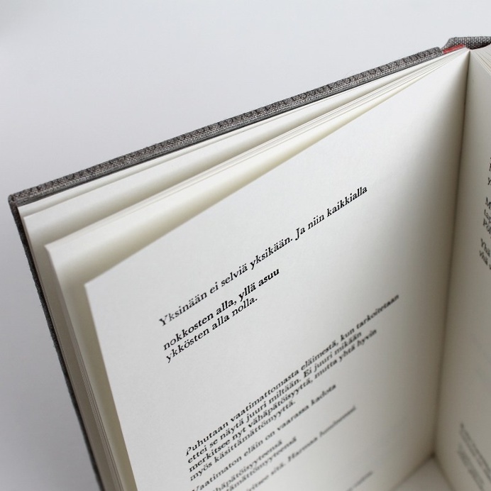 Designer binding by Kaija Rantakari, 2017. A variation of the sewn boards binding with typewritten binary code linen covers and pink leather