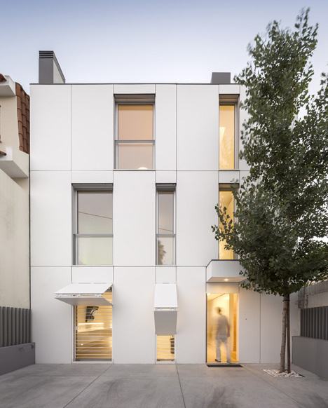 Hinged shutters camouflage with facade of townhouse by Humberto Conde